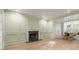 A living room with a fireplace that leads to the dining room at 245 Scotch Pine Ct, Alpharetta, GA 30022
