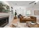 Living room with a fireplace, hardwood floors and views into the dining area at 245 Scotch Pine Ct, Alpharetta, GA 30022