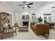 Inviting living room featuring a fireplace, wood floors, and views into the dining room at 245 Scotch Pine Ct, Alpharetta, GA 30022