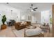 Spacious living room featuring a leather sofa, ceiling fan, and natural light at 245 Scotch Pine Ct, Alpharetta, GA 30022