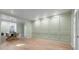 Light-filled living space with paneled walls, an open dining area, and pristine light-colored wood flooring at 245 Scotch Pine Ct, Alpharetta, GA 30022