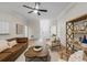 Spacious living room with wood floors, a ceiling fan, and white wainscoting detail at 245 Scotch Pine Ct, Alpharetta, GA 30022