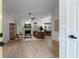 Open-concept living room with wood floors, fireplace, and views into the dining room at 245 Scotch Pine Ct, Alpharetta, GA 30022