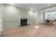 Bright living room with light-colored wood floors, fireplace, and an adjacent dining nook with natural light at 245 Scotch Pine Ct, Alpharetta, GA 30022