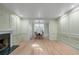Spacious living room with beautiful trim and a fireplace, flowing into a naturally lit dining space at 245 Scotch Pine Ct, Alpharetta, GA 30022