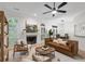 Bright living room featuring a fireplace, wood floors, and views into the dining room at 245 Scotch Pine Ct, Alpharetta, GA 30022