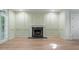 Elegant living room featuring paneled walls, a marble fireplace, and large windows for ample natural light at 245 Scotch Pine Ct, Alpharetta, GA 30022