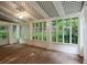 Bright sunroom with brick floors, multiple windows, and a ceiling fan at 245 Scotch Pine Ct, Alpharetta, GA 30022
