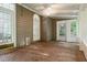 Bright sunroom with brick floors, multiple windows, and a ceiling fan at 245 Scotch Pine Ct, Alpharetta, GA 30022