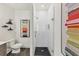 Modern bathroom with glass-enclosed shower, gray vanity, black tile floor, and stylish decor at 701 Pryor Sw St # 5, Atlanta, GA 30315