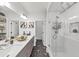 This bathroom offers a glass-enclosed shower and double sinks with modern fixtures and stylish black and white floors at 701 Pryor Sw St # 5, Atlanta, GA 30315