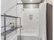 Stylish bathroom with tiled shower, white shower curtain, and shelving with decor at 701 Pryor Sw St # 5, Atlanta, GA 30315