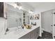 Bright bathroom with double sinks, modern fixtures, walk-in shower, and stylish black and white patterned floor at 701 Pryor Sw St # 5, Atlanta, GA 30315