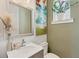 Stylish powder room with a decorative mirror, modern fixtures, and neutral decor at 701 Pryor Sw St # 5, Atlanta, GA 30315