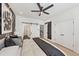 Bedroom featuring patterned wall, ceiling fan, sliding barn door and closet doors at 701 Pryor Sw St # 5, Atlanta, GA 30315