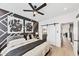 A bedroom is shown with a gray bed, modern art on the wall, and a sliding door to the bathroom at 701 Pryor Sw St # 5, Atlanta, GA 30315