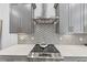 Elegant kitchen features a stainless steel range hood, gray cabinets, quartz countertops, and a tile backsplash at 701 Pryor Sw St # 5, Atlanta, GA 30315