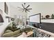 Bright living room with comfortable green couch, stylish zebra rug, a projector screen, and large windows for natural light at 701 Pryor Sw St # 5, Atlanta, GA 30315