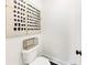 A cozy powder room offers a stylish accent wall, modern toilet, and black hardware at 701 Pryor Sw St # 5, Atlanta, GA 30315