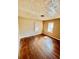 Bedroom with wood floors, two windows, and neutral paint at 1386 Bluefield Sw Dr, Atlanta, GA 30310