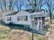 Charming single-Gathering home with a covered porch and mature trees surrounding the property at 1386 Bluefield Sw Dr, Atlanta, GA 30310