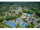 An aerial view showcases tennis courts, a pool, and a playground in the Hamilton Mill Lakeside community at 1608 Mulberry Lake Dr, Dacula, GA 30019