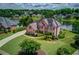 Beautiful brick home with lake view, lush trees, landscaping, and a long driveway at 1608 Mulberry Lake Dr, Dacula, GA 30019