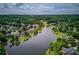 Stunning aerial view of lakeside homes surrounded by lush greenery and a serene lake at 1608 Mulberry Lake Dr, Dacula, GA 30019