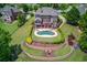 Aerial view showcasing the estate's sprawling lawn, outdoor entertainment spaces, and landscaping, offering privacy and space at 1608 Mulberry Lake Dr, Dacula, GA 30019