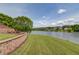 Expansive backyard lawn with a retaining wall leading down to the lake, perfect for outdoor activities and enjoyment at 1608 Mulberry Lake Dr, Dacula, GA 30019