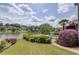 Tranquil backyard view showcasing manicured lawn, lush foliage, and a lake creating a serene and picturesque setting at 1608 Mulberry Lake Dr, Dacula, GA 30019