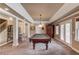 Spacious basement with a pool table, decorative columns, and a stylish ceiling at 1608 Mulberry Lake Dr, Dacula, GA 30019