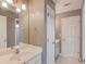 Bathroom with a single sink vanity, a large mirror, and ample storage at 1608 Mulberry Lake Dr, Dacula, GA 30019