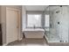 Bathroom featuring a standalone tub and glass enclosed shower at 1608 Mulberry Lake Dr, Dacula, GA 30019