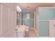 A spa-like bathroom with tile flooring, wainscotting and crown molding, and a white vanity with a single sink at 1608 Mulberry Lake Dr, Dacula, GA 30019