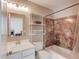 Well-lit bathroom features a shower-tub combination, white vanity, and a mirror at 1608 Mulberry Lake Dr, Dacula, GA 30019
