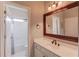 Bathroom with white vanity, framed mirror, and shower/tub combo with tile surround at 1608 Mulberry Lake Dr, Dacula, GA 30019