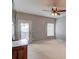 A carpeted bedroom with a ceiling fan and exterior access to the backyard at 1608 Mulberry Lake Dr, Dacula, GA 30019