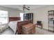 Cozy bedroom with wood-look floors, a ceiling fan, and natural light from the windows at 1608 Mulberry Lake Dr, Dacula, GA 30019