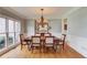 Formal dining room boasts hardwood floors, neutral walls, large window, and chandelier at 1608 Mulberry Lake Dr, Dacula, GA 30019