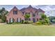 Charming two-story brick home with manicured lawn and beautiful landscaping at 1608 Mulberry Lake Dr, Dacula, GA 30019