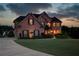Brick house featuring symmetrical design, dark shutters, and a well-manicured lawn on a large lot at 1608 Mulberry Lake Dr, Dacula, GA 30019