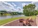 Lakeside outdoor space with a charming fire pit and Adirondack chairs providing the perfect spot for relaxation at 1608 Mulberry Lake Dr, Dacula, GA 30019