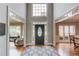 Grand foyer with high ceilings, hardwood floors, elegant front door, and spacious entryway at 1608 Mulberry Lake Dr, Dacula, GA 30019