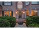 A close-up of a home's entrance with a decorative door, sidelights, and manicured shrubs at 1608 Mulberry Lake Dr, Dacula, GA 30019