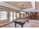 Open floor plan game room includes a pool table and a wet bar with convenient access to the outdoor pool at 1608 Mulberry Lake Dr, Dacula, GA 30019