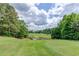 Scenic view of the community golf course, with lush green fairways and serene water features at 1608 Mulberry Lake Dr, Dacula, GA 30019