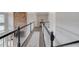 Upstairs hallway with beautiful trim and a view of the living room below at 1608 Mulberry Lake Dr, Dacula, GA 30019