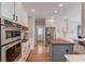 A modern kitchen features stainless appliances, a gas cooktop, and a butcher block island at 1608 Mulberry Lake Dr, Dacula, GA 30019