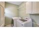 A functional laundry room equipped with a washer, dryer, and shelving for storage at 1608 Mulberry Lake Dr, Dacula, GA 30019